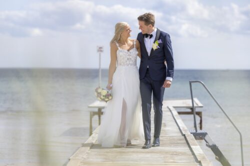 Smuk og romantisk pre-loved brudekjole med masser af 3-D blomster på overkroppen der fader ned på et let og blødt tylskørt. Kjolen har stropper og en skjult slids i skørtet under de yderste tyllag. Meget lidt slæb.